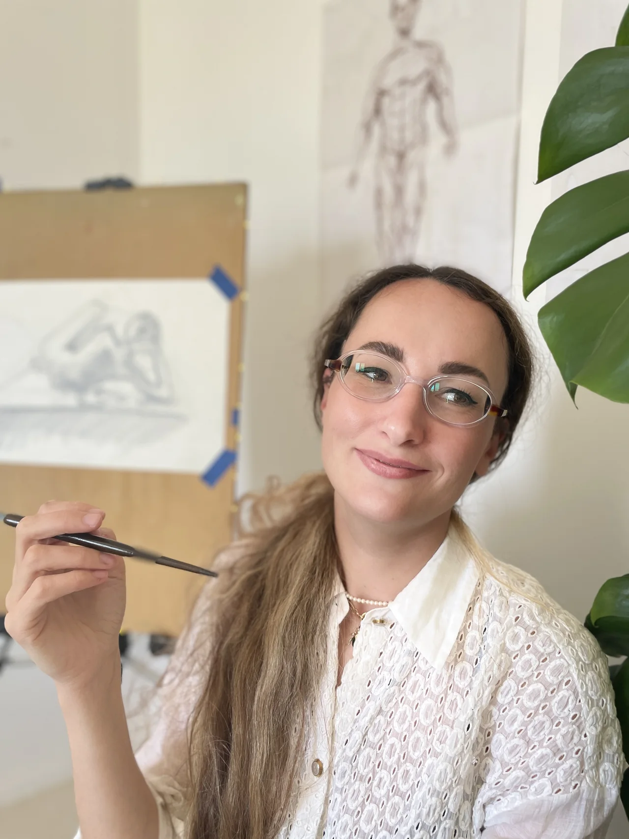 Sveta Dietrich in her studio, holding a paintbrush